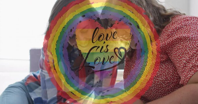 Animation of rainbow circle and love is love over lesbian couple petting dog