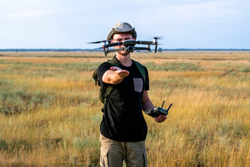 a tourist guy launches a quadcopter with his hand in front of him
