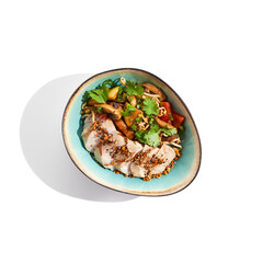 Healthy food in asian restaurant. Chicken breast grilled with roasted vegetables and coriander. Sliced Chicken fillet steak with teriyaki vegetables. Asian vegetables on wok with backed chicken.