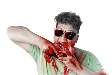 A scary zombie in sunglasses with blood and wound on his body eat the raw meat