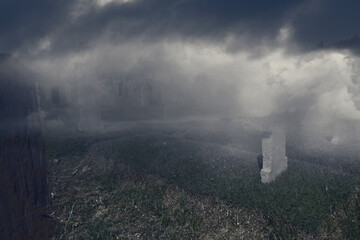 Fototapeta na wymiar Tombstones on the graveyard with the foggy background