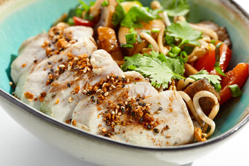 Healthy food in asian restaurant. Chicken breast grilled with roasted vegetables and coriander. Sliced Chicken fillet steak with teriyaki vegetables. Asian vegetables on wok with backed chicken.