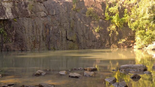 Quiet Natural Waterhole With Mossy Rugged Cliffs In Cedar Creek Falls In QLD Australia. Static