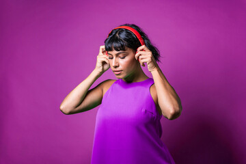 Young caucasian person listens to music, wearing red music headphones.