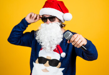 Congratulating his nearest. christmas songs. xmas shopping time. prepare gifts and presents. karaoke. happy bearded man in santa hat sing in microphone. new year party. celebrate winter holidays