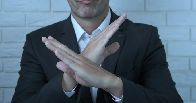 Forbidding gesture. A man show a stop gesture. A concept of problems in business and at work.