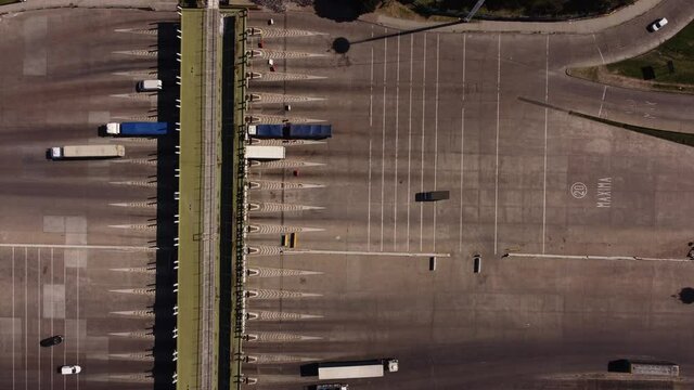 Aerial top down shot of trucks arriving toll after driving on highway in Buenos Aires - Payment of toll fee in Argentina