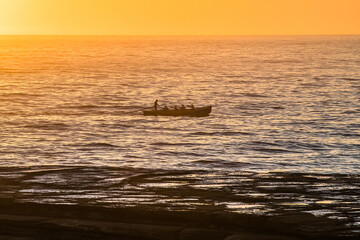 Sunrise Seascape with silhoutte of rowers