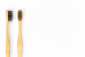 Bamboo toothbrushes on white background. Copy Space.