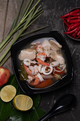 Tom Yum, Clear Soup, Chicken, Shrimp, Squid, popular Thai food mixed boiled lime, chili, mushroom, lemongrass, herbs