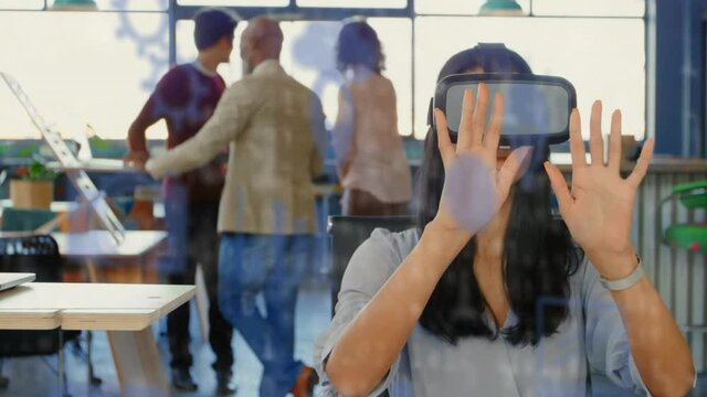 Animation of social media icons and data processing over mixed race woman wearing vr headset