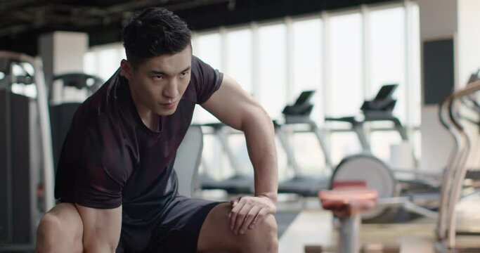 Young man working out with dumbbell at gym,4K