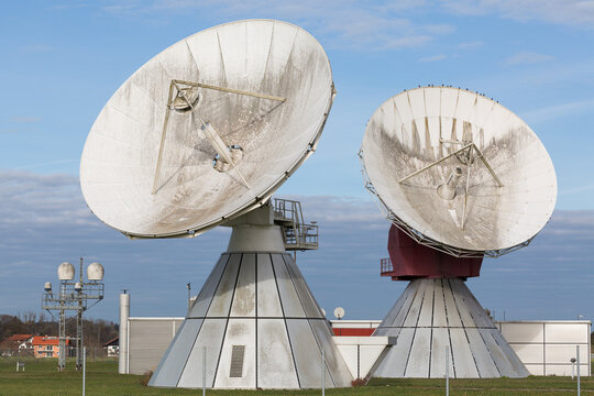 Two satellite dishes. Blue sky in the background (Raisting, Bavaria, Germany).