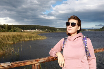Woman on bridge against background of Lake Ladoga
