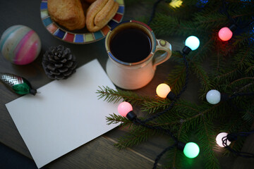 Hot Christmas tea or coffee in a mug by the Christmas tree with Christmas lights and decorations, Christmas background