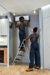 Two workers providing regular air conditioning service