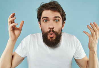 emotional man in a white t-shirt expressive look Studio