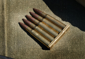 Belts and clips of cartridges for military world war two weapons.