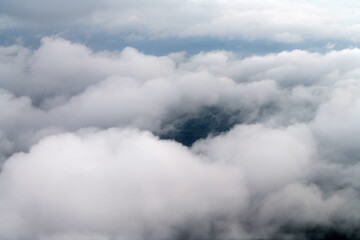 Clouds and sky as seen through window of an aircraft