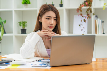 Fototapeta na wymiar Portrait Of Attractive Asian Businesswoman Working On Laptop for marketing plan
