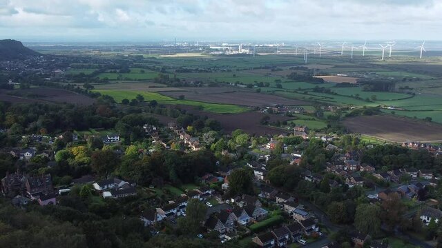 Cheshire farmland countryside wind farm turbines generating renewable green energy aerial view left wide orbit