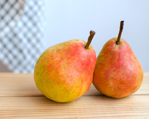 Two ripe red and yellow pears close up. Country style