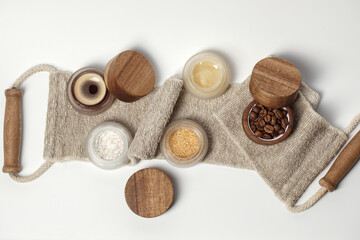 Brown sugar, coffee and honey ingredients for scrub in glass jars with wooden lid on exfoliating body strap for homemade cosmetic. Beauty, Spa, skin care, aromatherapy concept
