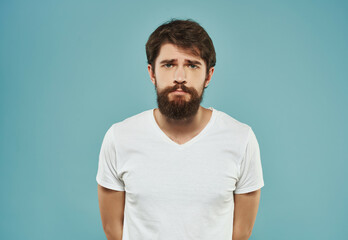 Fototapeta premium emotional man in a white t-shirt expressive look discontent close-up