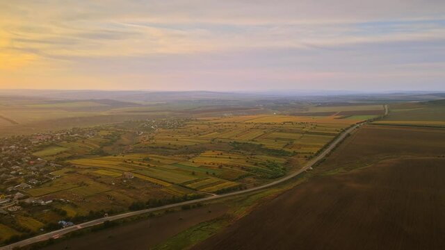 Aerial drone view of nature in Moldova at sunset. Village, fields and hills