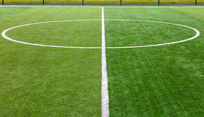 White circle on green grass on a soccer field.