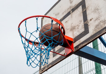 The basketball ball flies into the basket.