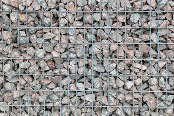 Stones in a metal grid as an abstract background.