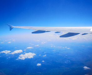 Airplane wing in sky in flight.