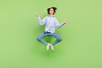 Fototapeta na wymiar Full body photo of cheerful young calm happy woman jump up asana yoga isolated on green color background