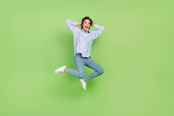 Full body photo of happy cheerful amazed shocked woman jump up hand head sale isolated on green color background