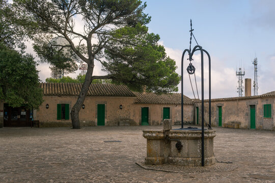 Square with a medieval stone well, located in the Christian sanctuary of Randa, island of Mallorca, Spain