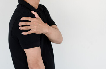 Healthcare concept, a man has severe shoulder pain due to overwork and office syndrome.