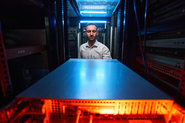 Data center worker doing maintenance of computer equipment