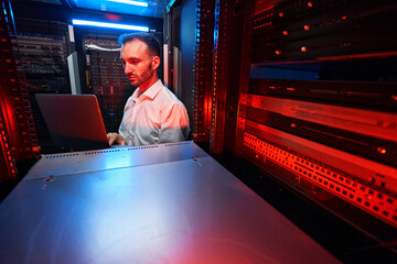 Data center administrator inspecting server rack software