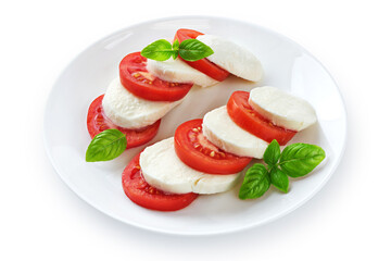 Caprese salad with fresh tomatoes, mozzarella cheese and basilic isolated on white background. With clipping path.