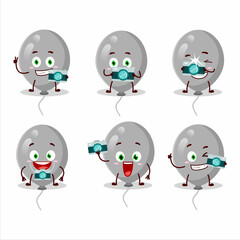Fototapeta premium Photographer profession emoticon with grey balloons cartoon character
