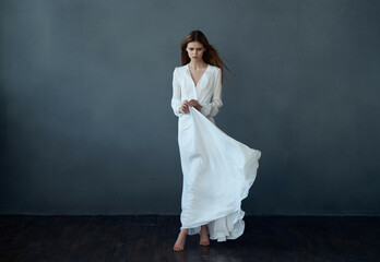 Fototapeta na wymiar woman white dress fashion elegant style studio dark background posing