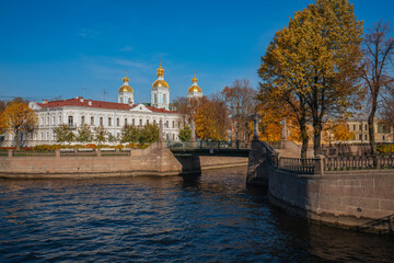 View of the Krasnogvardeysky Bridge over the Griboyedov Canal and the dome of the St. Nicholas Naval Cathedral on a sunny autumn day, St. Petersburg, Russia