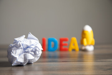 lettering idea, crumpled paper and rocket on the table