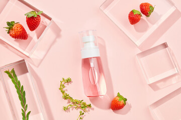 Cosmetic bottle containers with strawberry extract and scientific glassware. Research and develop natural organic beauty skincare product concept. Blank label for mockup. Top view. 