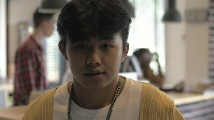 Happy successful confident millennial asian chinese or korean man smiling looking at camera. Portrait of motivated teenage teenager student male