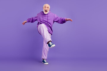 Fototapeta na wymiar Full length body size view of attractive cool cheerful man moving fooling having fun isolated over bright violet purple color background