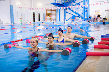 Avka aerobics in the swimming pool. A group of young people in training.