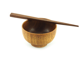 Empty wooden bowl and chopsticks isolated on a white background.  Used  serving for home or...