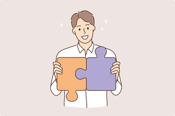 Strategy, career and development concept. Young smiling man cartoon character making pieces of puzzle together feeling confident vector illustration 